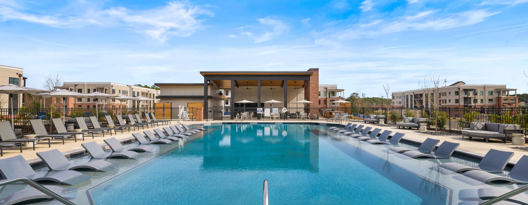 swimming pool with chairs around it outside