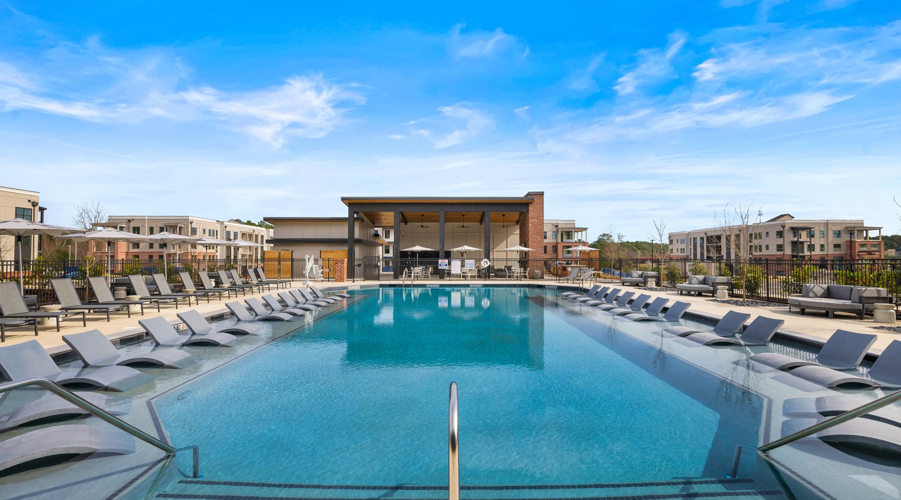 swimming pool with chairs around it outside